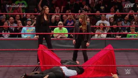 Ronda Rousey Signs Her WWE Contract At ELIMINATION CHAMBER And Puts Triple H Through A Table!