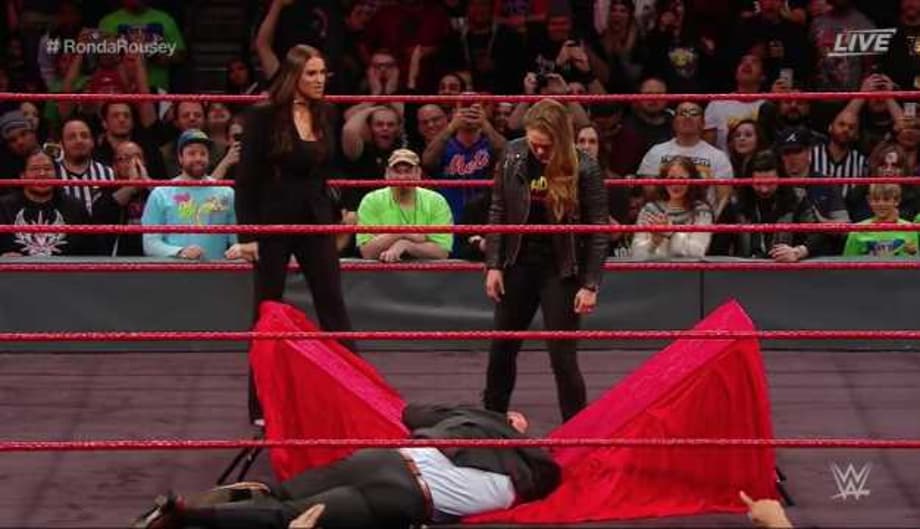 Ronda Rousey Signs Her WWE Contract At ELIMINATION CHAMBER And Puts Triple H Through A Table!